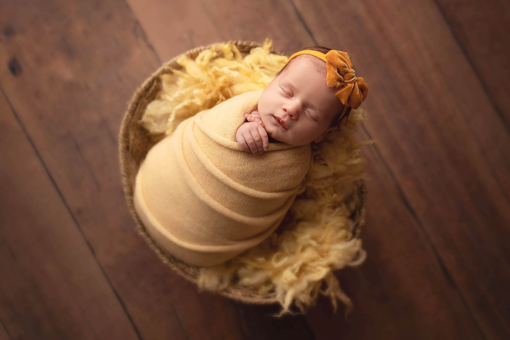 Baby posed in a yellow basket